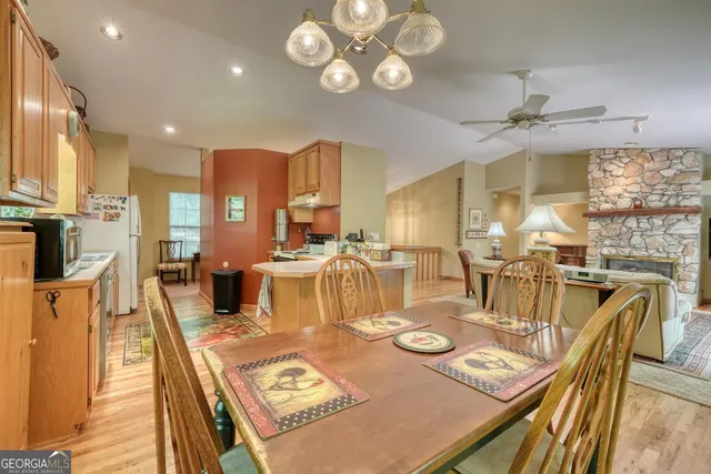 a kitchen with a table chairs refrigerator and cabinets