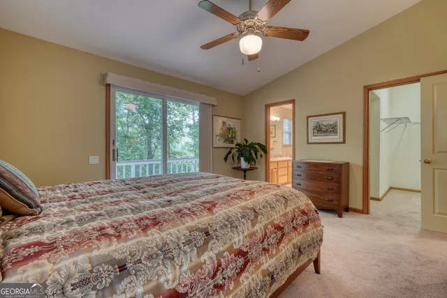 a bedroom with a bed and a chandelier fan