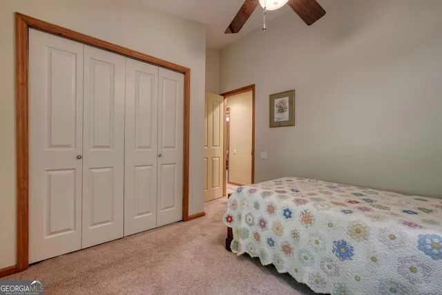 an empty room with chandelier fan