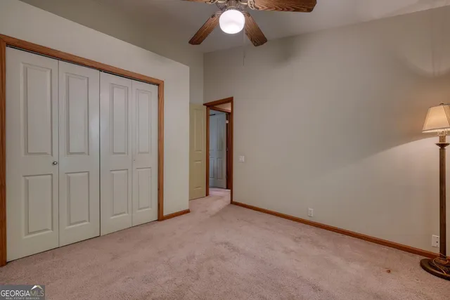 a view of a balcony with plants and wooden fence