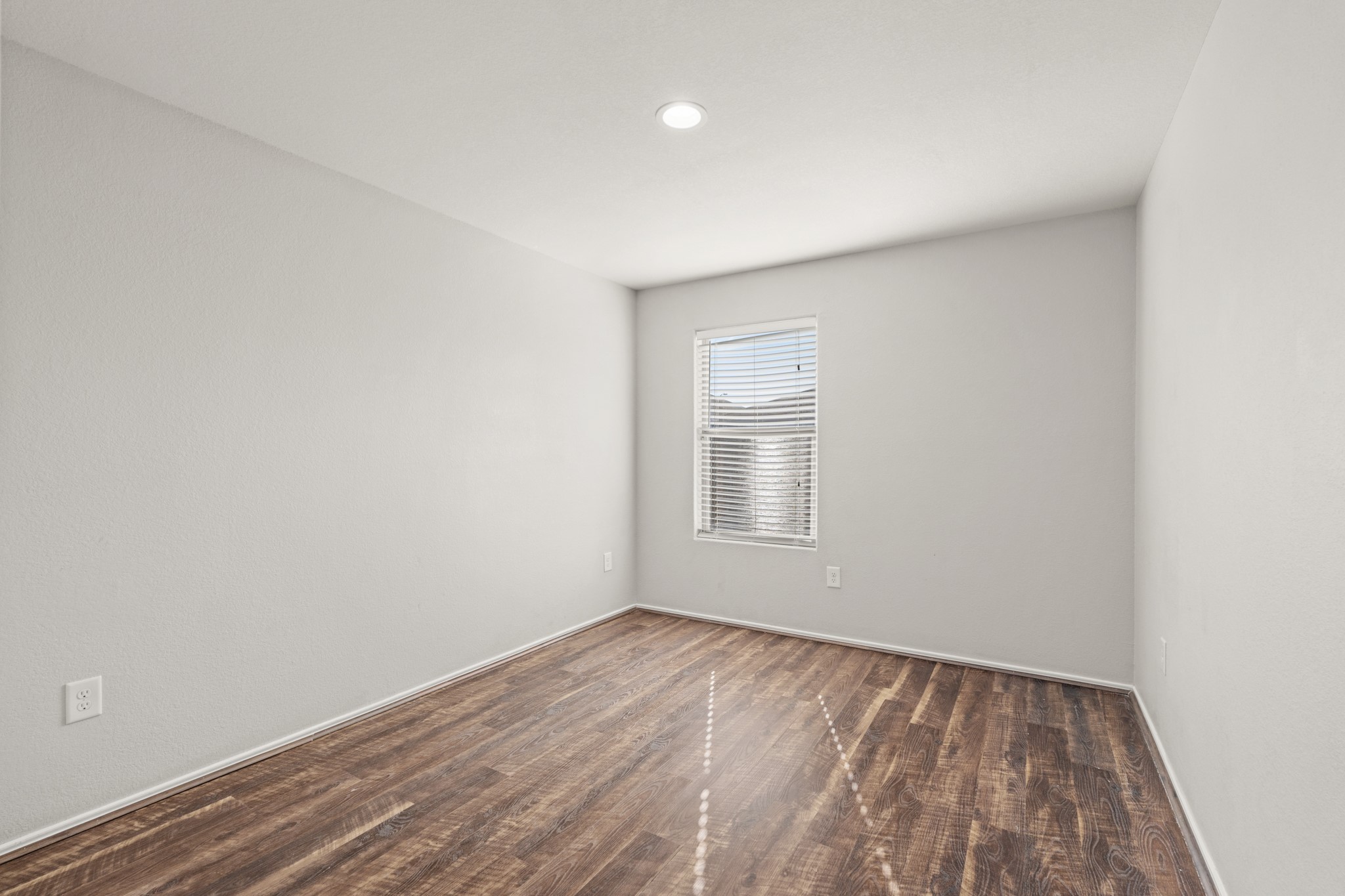 21359 Bandera Ranch Lane Katy, TX 77449 - Photo 13 of 31 a view of an empty room with wooden floor and a window