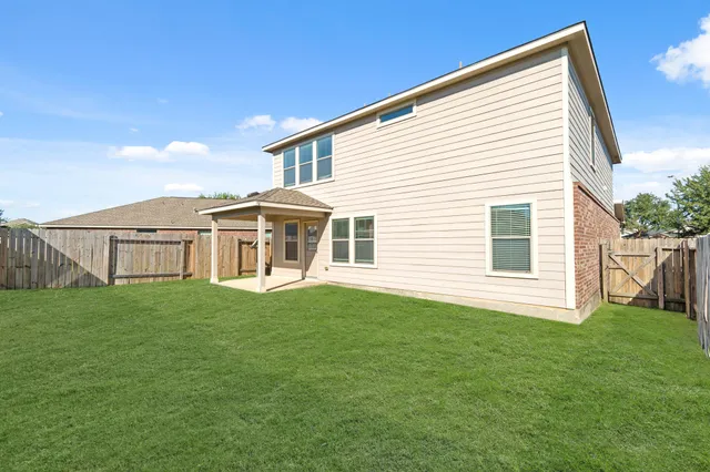 a view of a house with a backyard