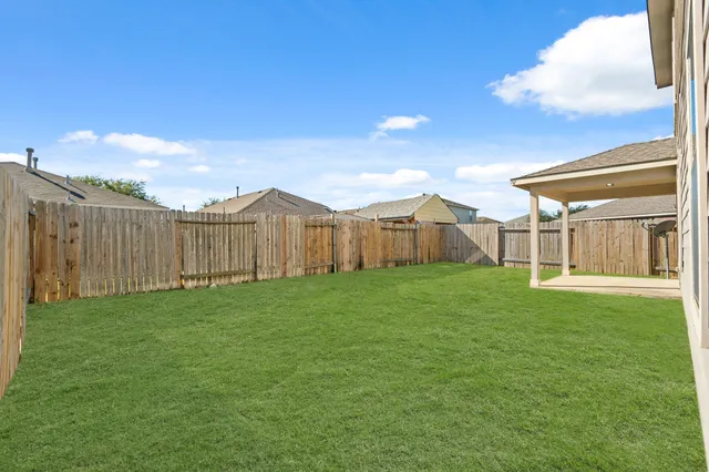 a view of a house with backyard and garden