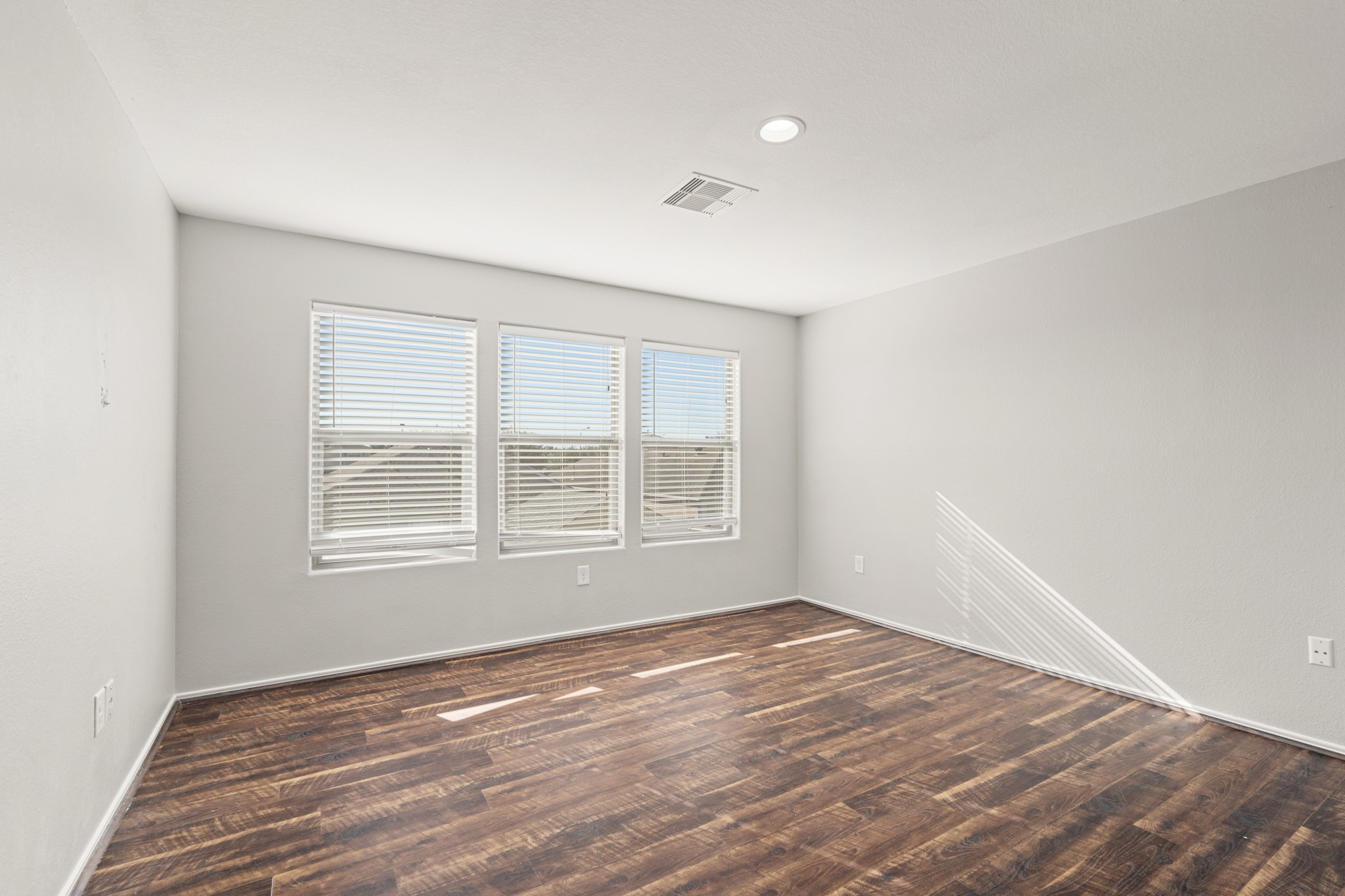 21359 Bandera Ranch Lane Katy, TX 77449 - Photo 18 of 31 an empty room with wooden floor and windows