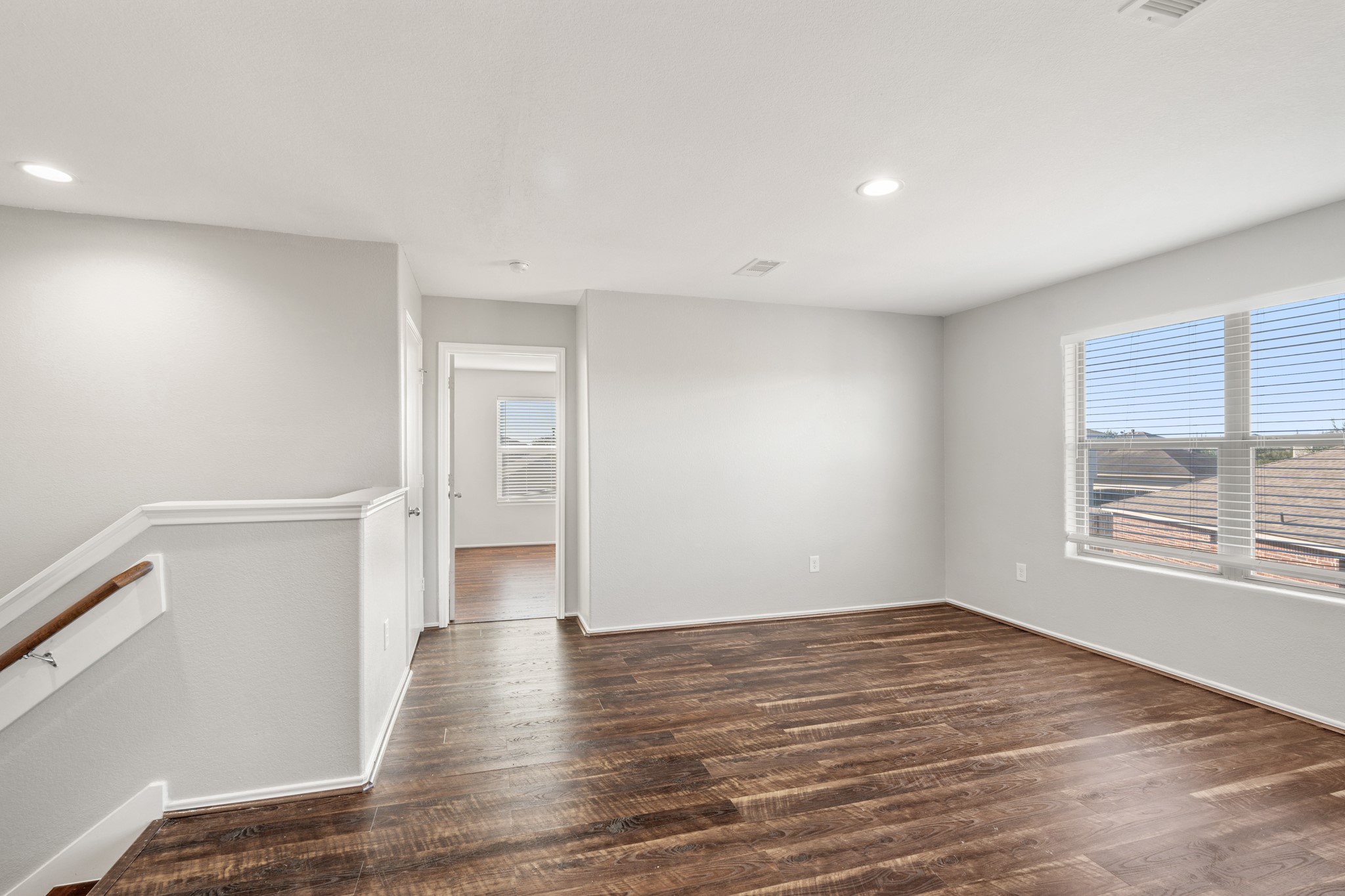 21359 Bandera Ranch Lane Katy, TX 77449 - Photo 22 of 31 a view of an empty room with wooden floor and a window