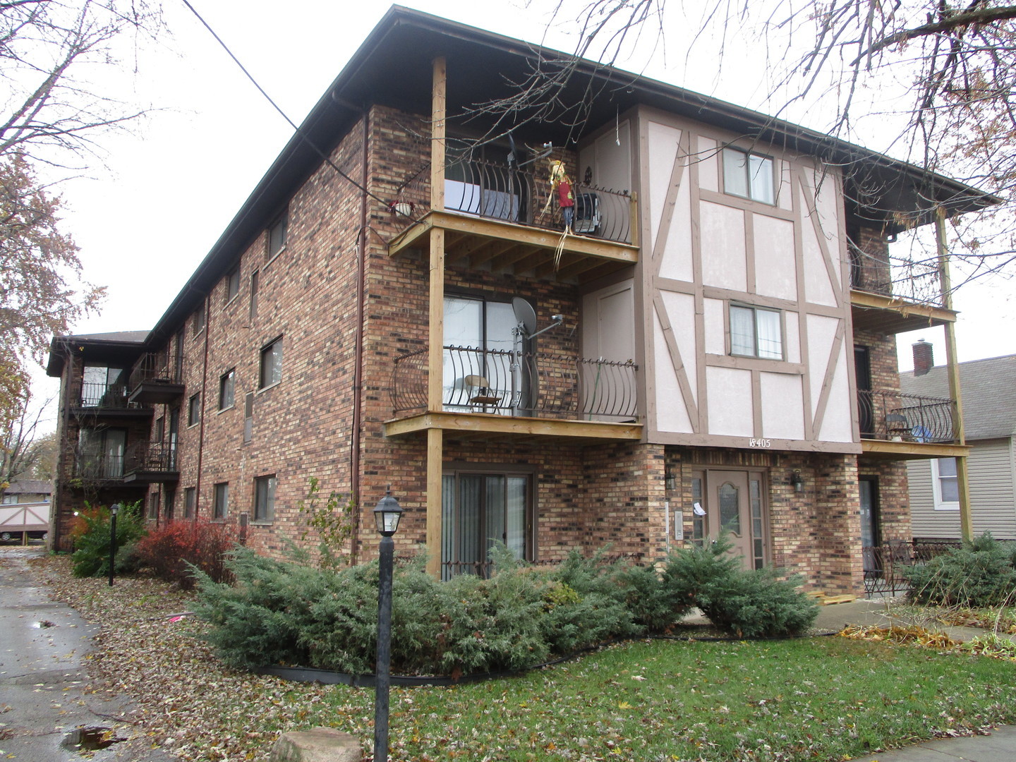a view of a house with large windows and plants