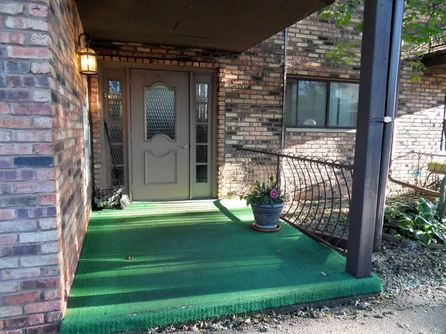 a front view of building with yard and green space