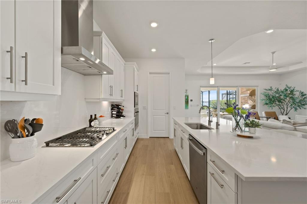 13654 Blue Bay Circle Fort Myers, FL 33913 - Photo 11 of 50 a view of a kitchen counter space a sink wooden floor and kitchen