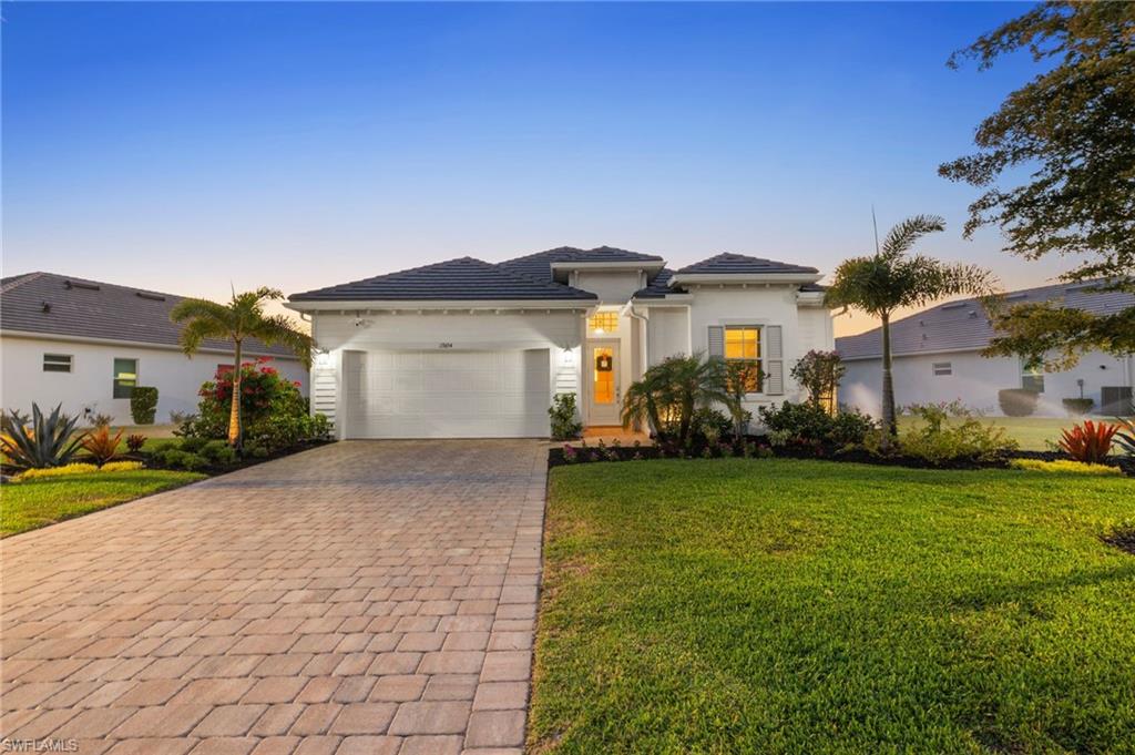 13654 Blue Bay Circle Fort Myers, FL 33913 - Photo 2 of 50 a front view of a house with garden