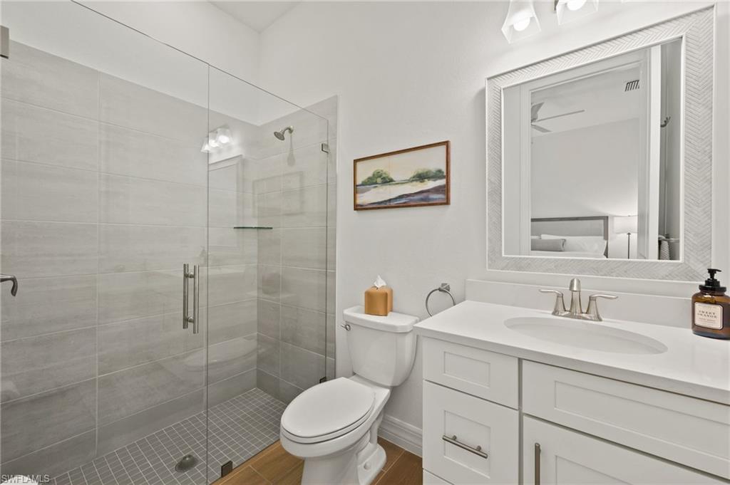13654 Blue Bay Circle Fort Myers, FL 33913 - Photo 22 of 50 a bathroom with a toilet sink vanity and shower