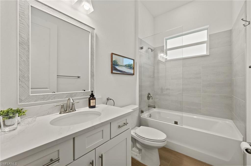 13654 Blue Bay Circle Fort Myers, FL 33913 - Photo 24 of 50 a bathroom with a sink a toilet and a bathtub