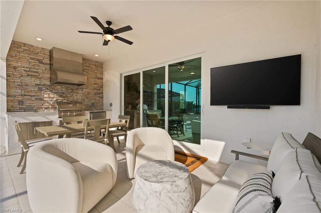 13654 Blue Bay Circle Fort Myers, FL 33913 - Photo 28 of 50 a living room with furniture a flat screen tv and a floor to ceiling window