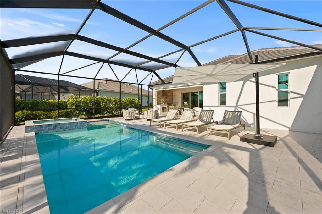 13654 Blue Bay Circle Fort Myers, FL 33913 - Photo 32 of 50 a view of a swimming pool with a patio