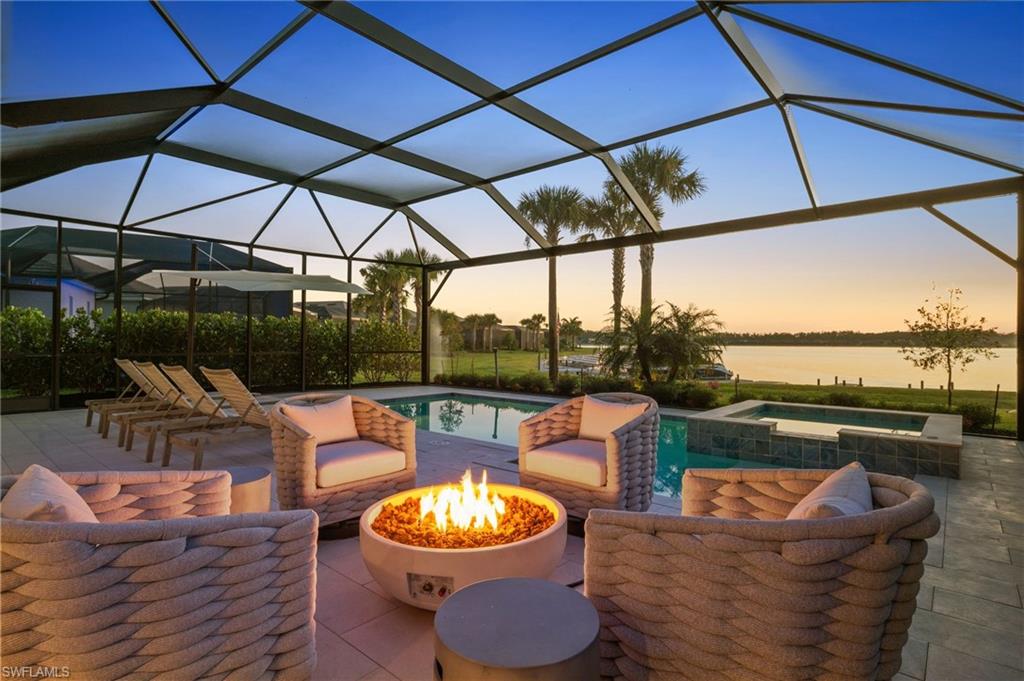 13654 Blue Bay Circle Fort Myers, FL 33913 - Photo 37 of 50 a view of a roof deck with couches under an umbrella