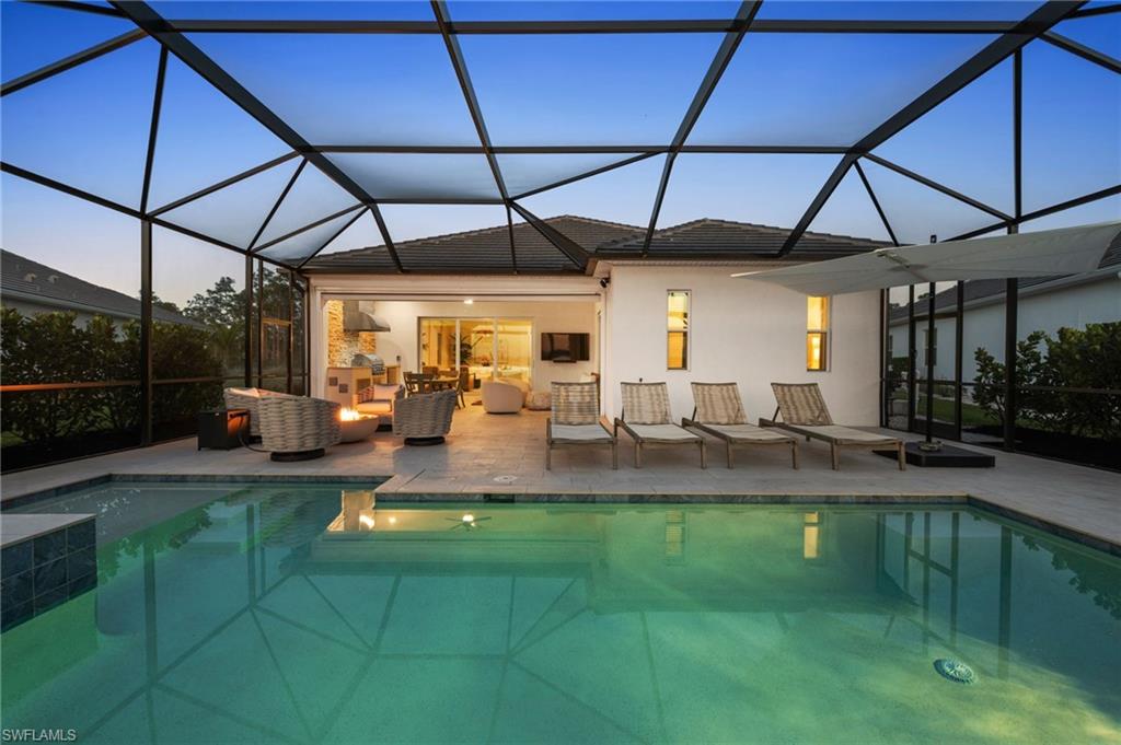 13654 Blue Bay Circle Fort Myers, FL 33913 - Photo 39 of 50 a view of a patio with table and chairs under an umbrella