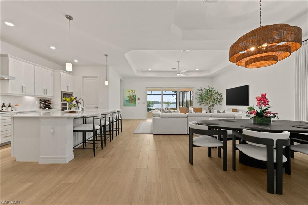 13654 Blue Bay Circle Fort Myers, FL 33913 - Photo 6 of 50 a view of a dining room with furniture and wooden floor