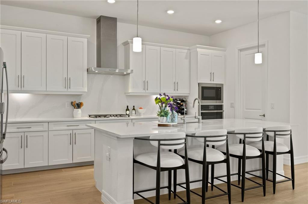 13654 Blue Bay Circle Fort Myers, FL 33913 - Photo 7 of 50 a kitchen with granite countertop white cabinets and stainless steel appliances