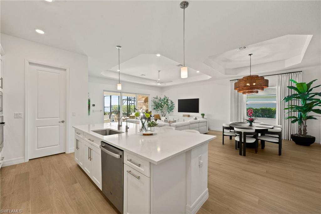 13654 Blue Bay Circle Fort Myers, FL 33913 - Photo 10 of 50 a large white kitchen with a large island in the center