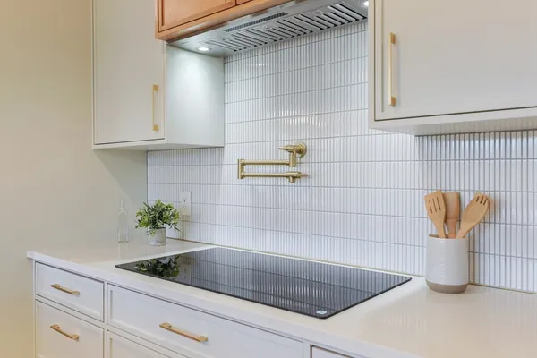 a kitchen with white cabinets and white appliances