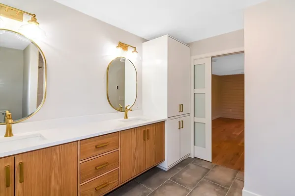 a spacious bathroom with a granite countertop sink mirror and shower