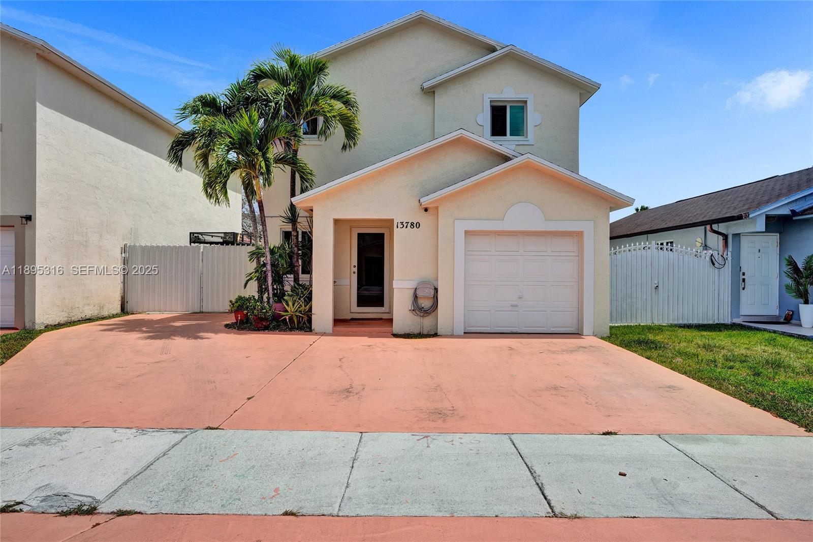 13780 Southwest 160th Terrace Miami, FL 33177 - Photo 1 of 42 a front view of a house with a yard and garage