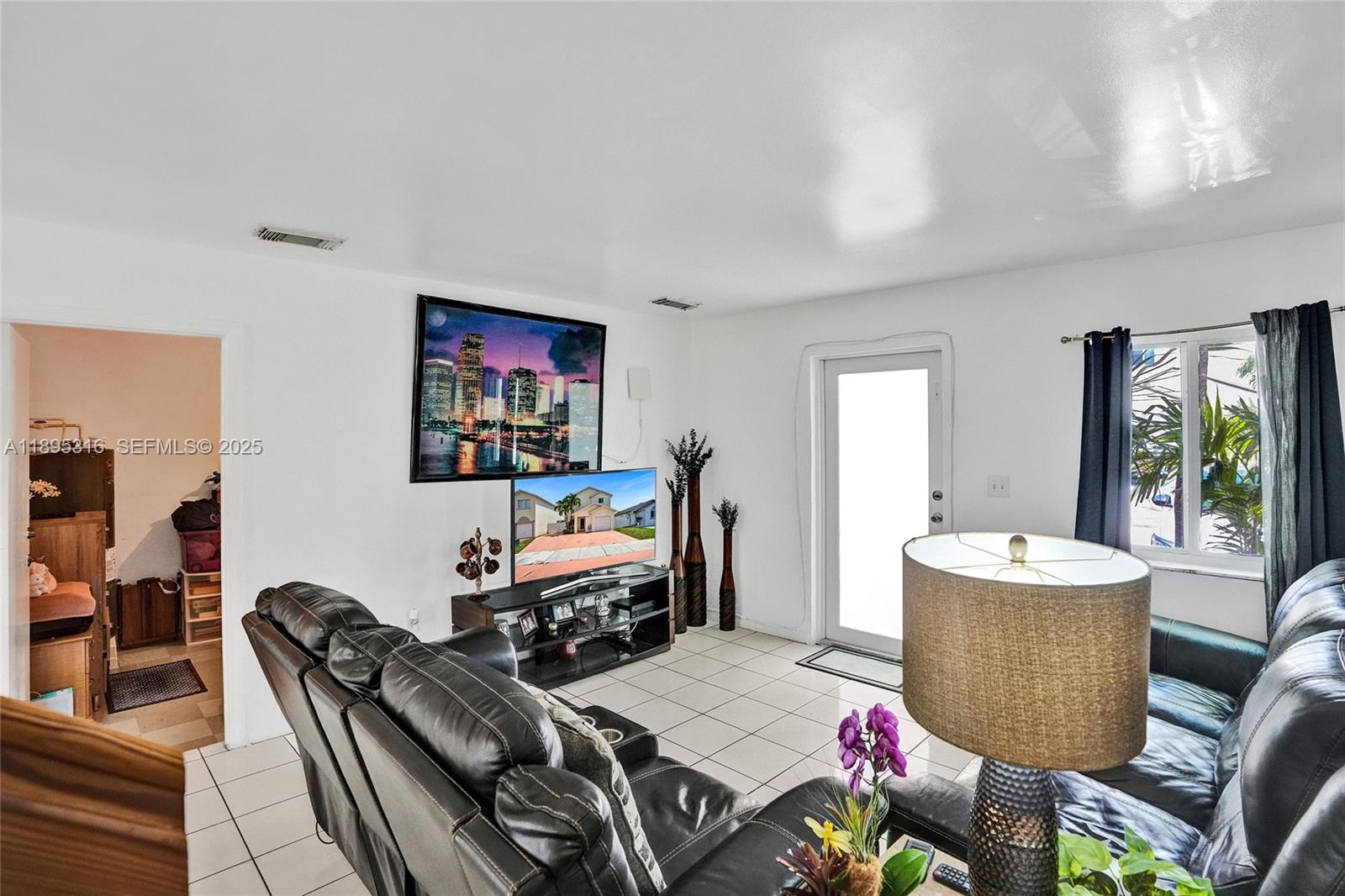13780 Southwest 160th Terrace Miami, FL 33177 - Photo 12 of 42 a living room with furniture and a flat screen tv