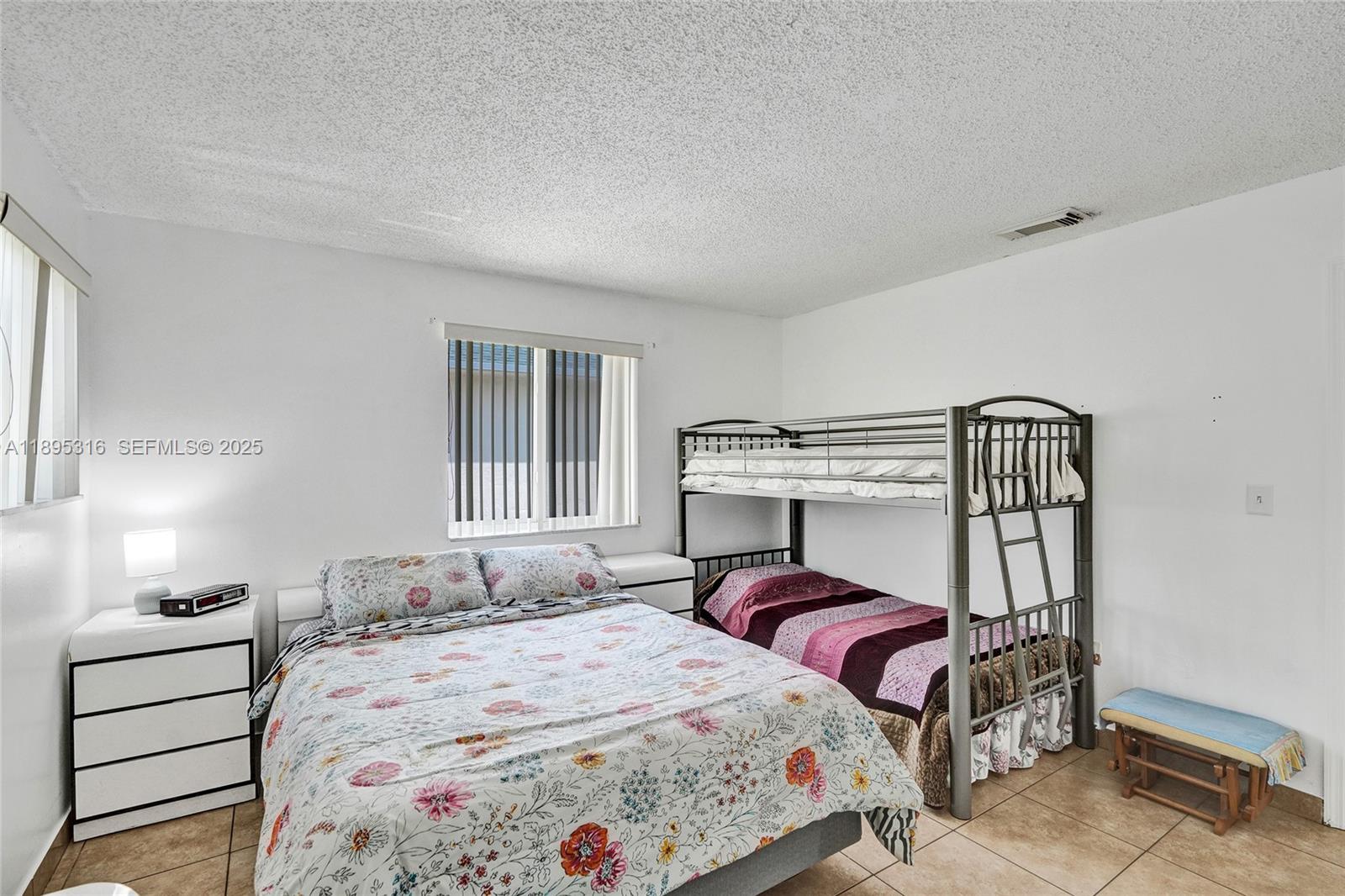 13780 Southwest 160th Terrace Miami, FL 33177 - Photo 19 of 42 a bedroom with a bed and a window