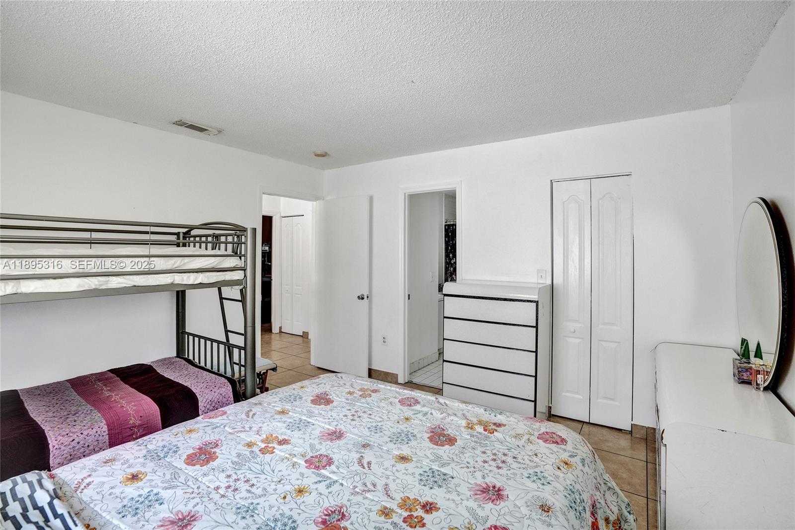 13780 Southwest 160th Terrace Miami, FL 33177 - Photo 20 of 42 a bedroom with a bed and a dresser