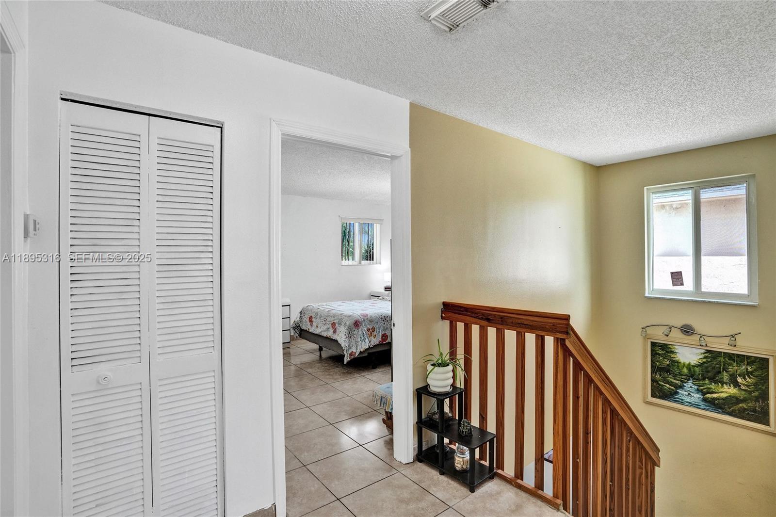 13780 Southwest 160th Terrace Miami, FL 33177 - Photo 21 of 42 a view of a hallway with a bedroom and windows