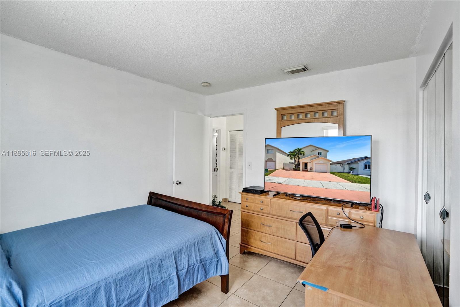 13780 Southwest 160th Terrace Miami, FL 33177 - Photo 23 of 42 a bedroom with a bed and a table in it