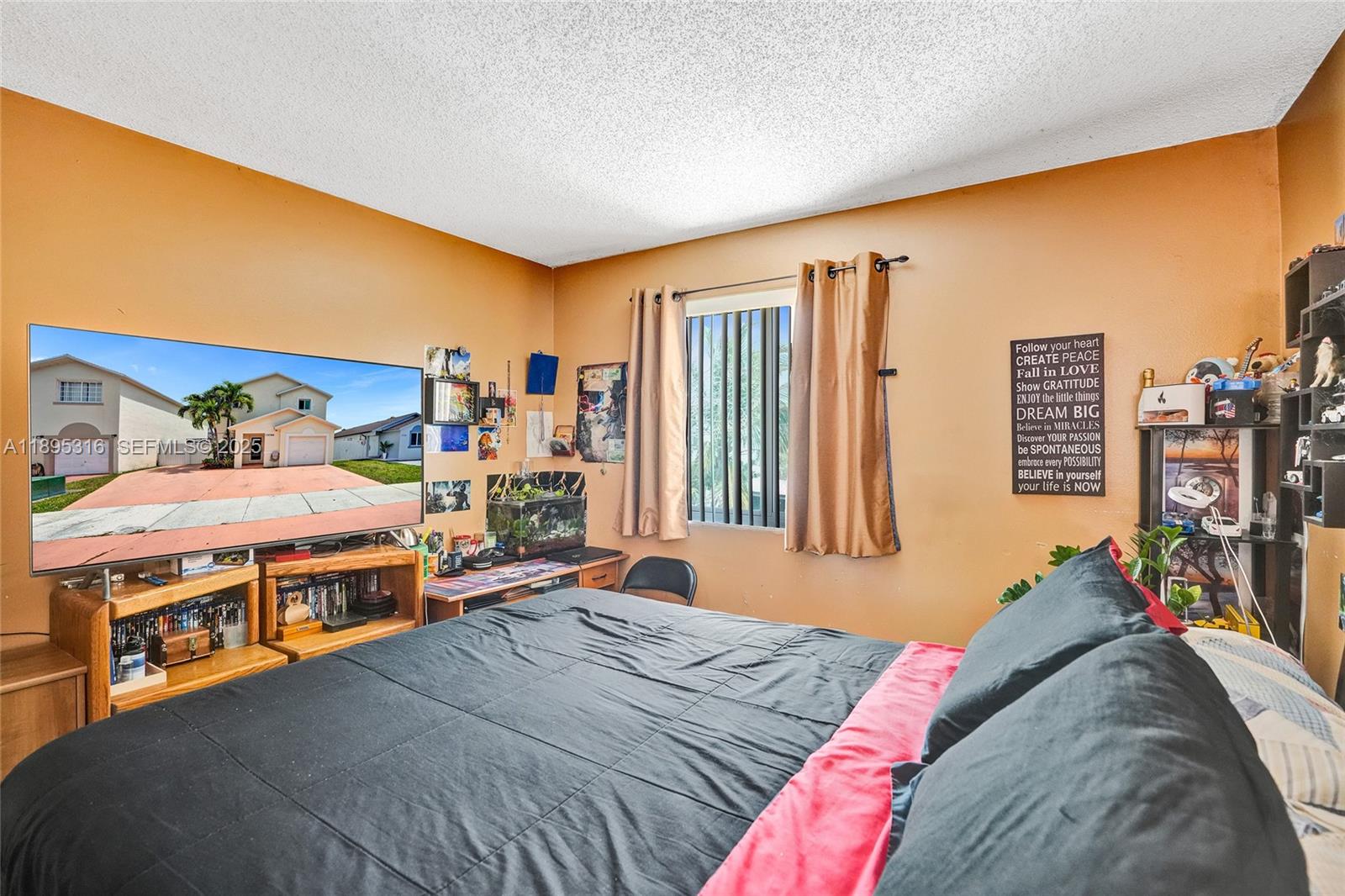 13780 Southwest 160th Terrace Miami, FL 33177 - Photo 25 of 42 a bedroom with a bed and large windows