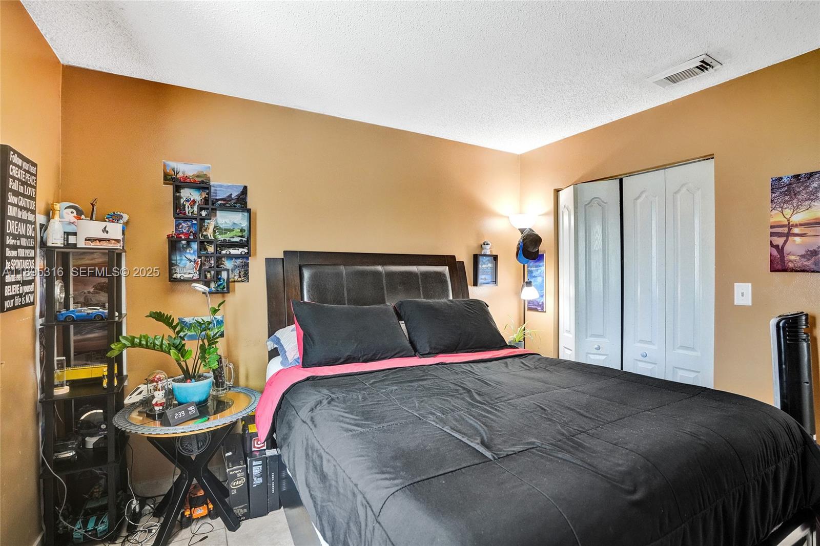 13780 Southwest 160th Terrace Miami, FL 33177 - Photo 26 of 42 a bedroom with a bed and dresser