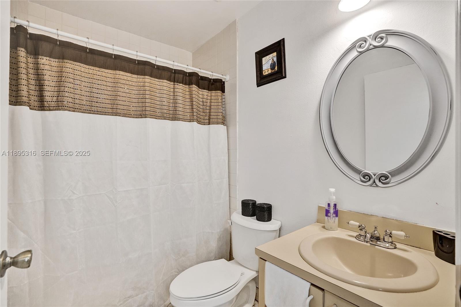 13780 Southwest 160th Terrace Miami, FL 33177 - Photo 27 of 42 a bathroom with a sink a mirror a toilet and a mirror
