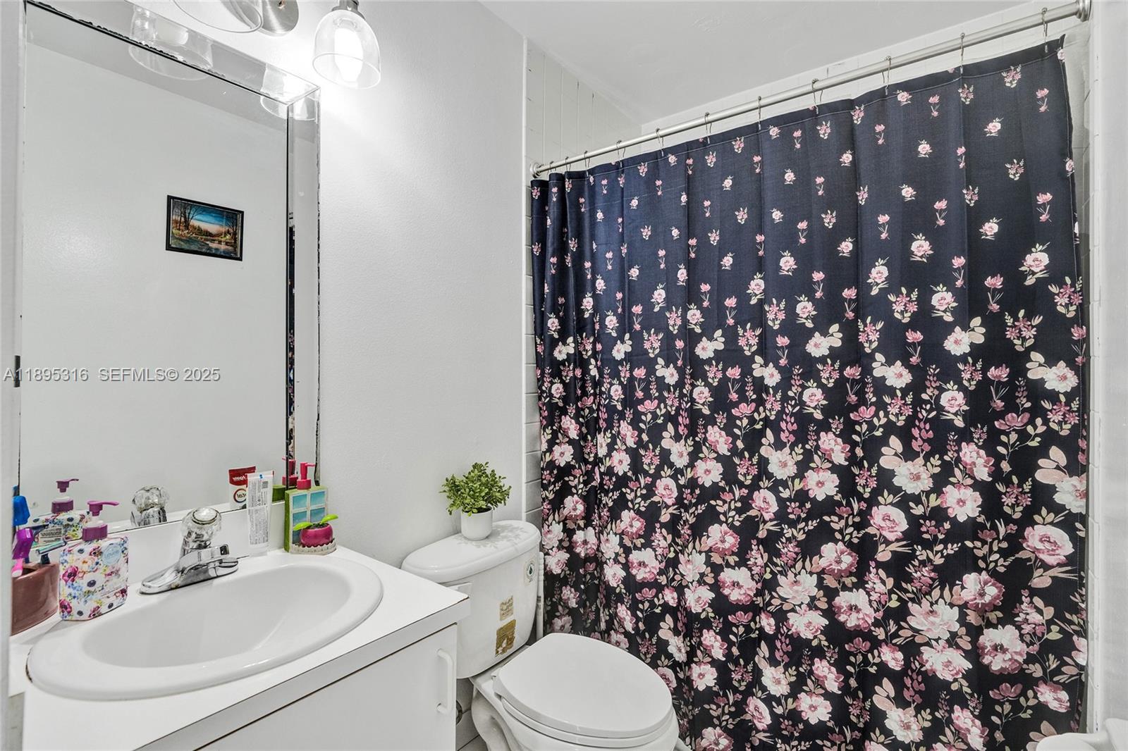 13780 Southwest 160th Terrace Miami, FL 33177 - Photo 32 of 42 a bathroom with a sink toilet and mirror