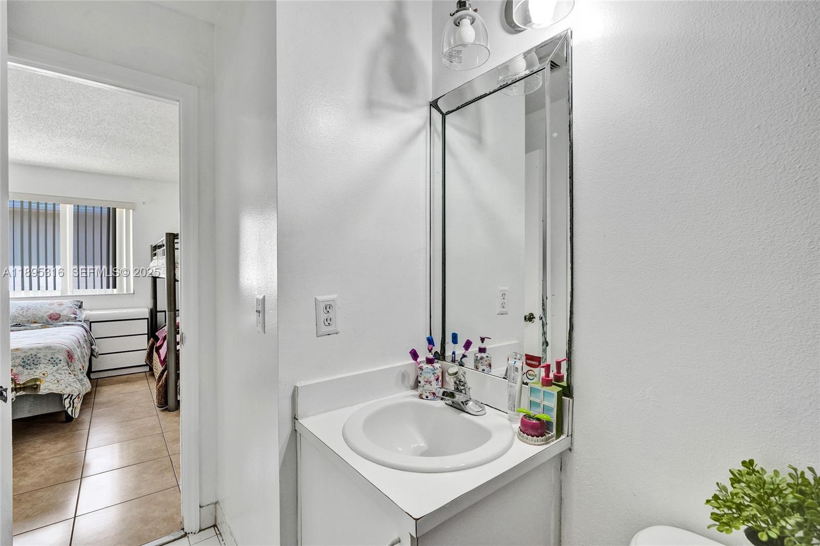 13780 Southwest 160th Terrace Miami, FL 33177 - Photo 33 of 42 a bathroom with a sink and a mirror