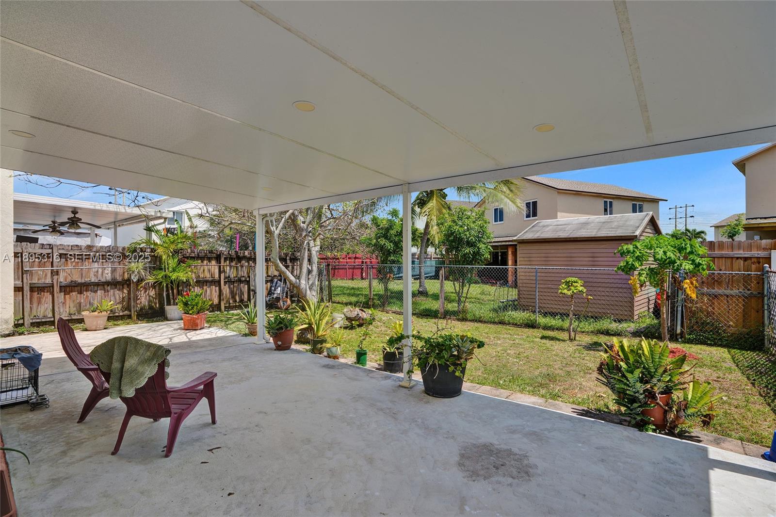 13780 Southwest 160th Terrace Miami, FL 33177 - Photo 34 of 42 a backyard of a house with yard and outdoor seating