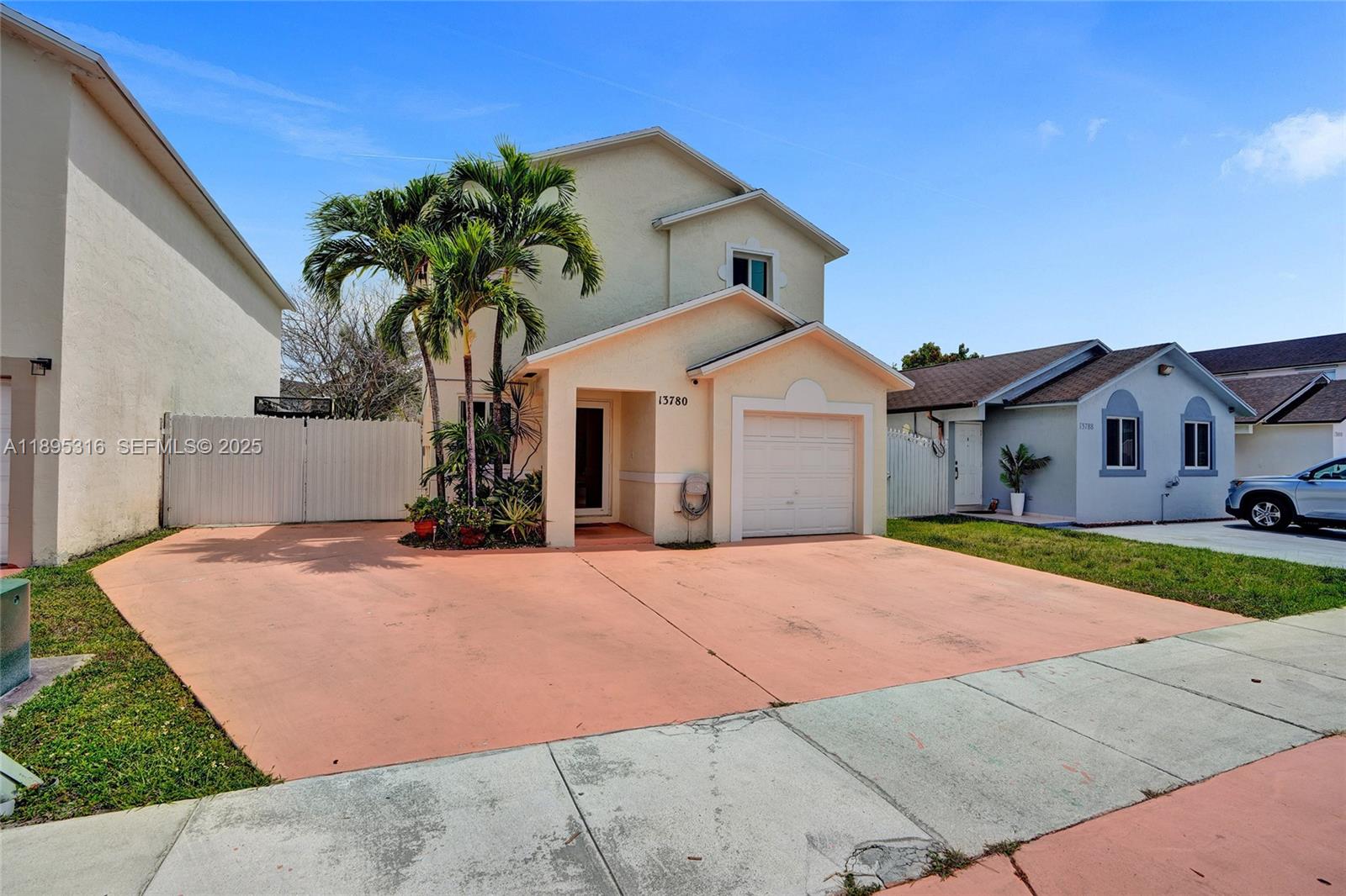 13780 Southwest 160th Terrace Miami, FL 33177 - Photo 39 of 42 a front view of a house with a yard and garage
