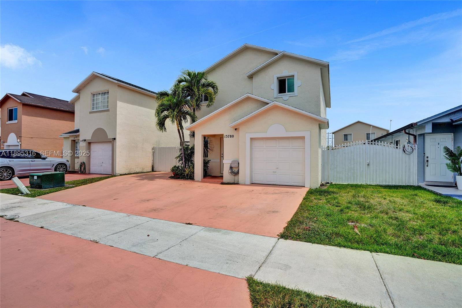 13780 Southwest 160th Terrace Miami, FL 33177 - Photo 41 of 42 a front view of a house with a yard and garage