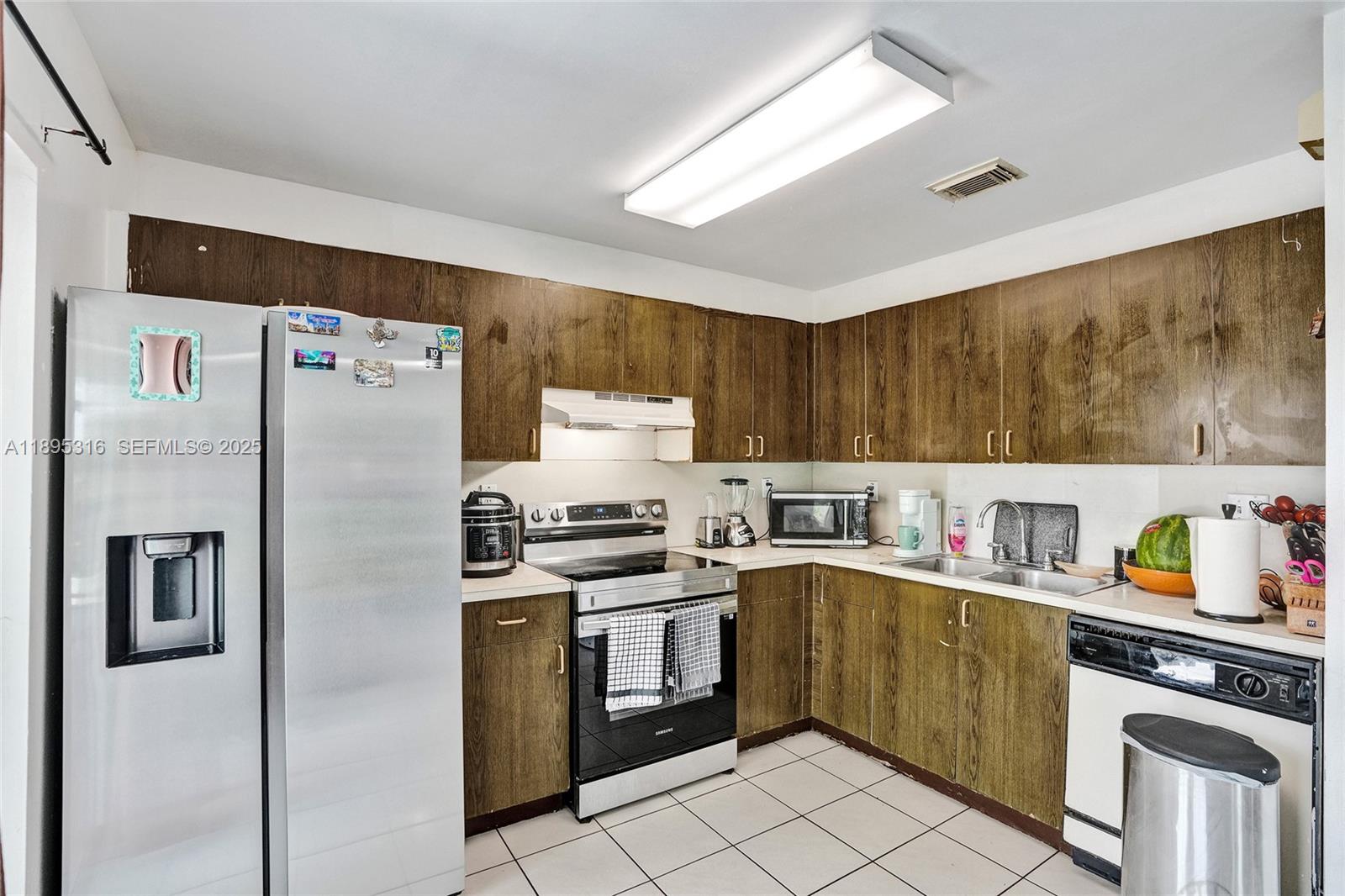 13780 Southwest 160th Terrace Miami, FL 33177 - Photo 5 of 42 a kitchen with a stove top oven sink and refrigerator