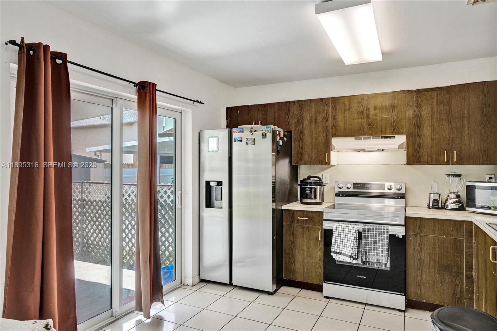 13780 Southwest 160th Terrace Miami, FL 33177 - Photo 6 of 42 a kitchen with stainless steel appliances granite countertop a refrigerator and a stove