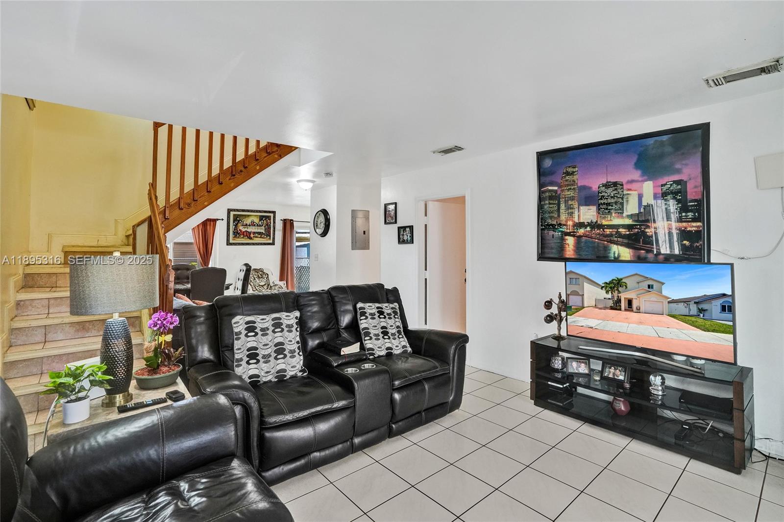 13780 Southwest 160th Terrace Miami, FL 33177 - Photo 9 of 42 a living room with furniture and a baby crib