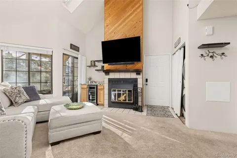 a living room with fireplace furniture and a flat screen tv