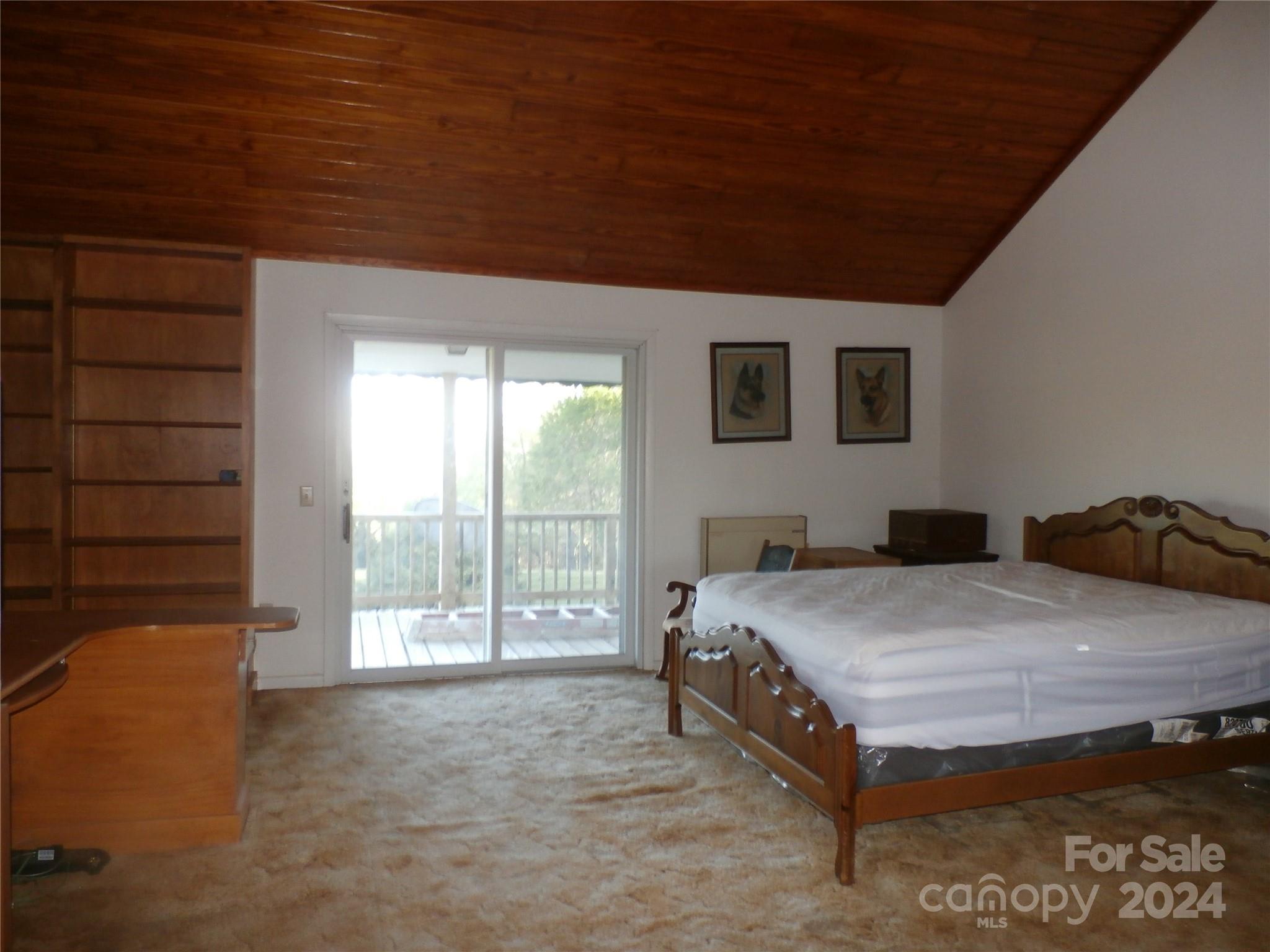 288 Firetower Road Spruce Pine, NC 28777 - Photo 16 of 47 a bed sitting in a spacious bedroom next to a window