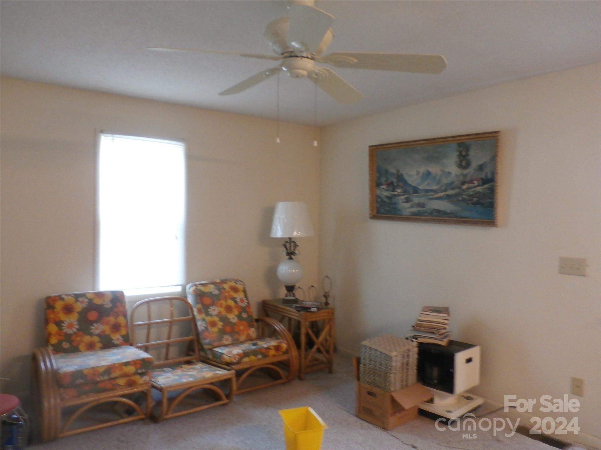 288 Firetower Road Spruce Pine, NC 28777 - Photo 41 of 47 a living room with furniture and a chandelier
