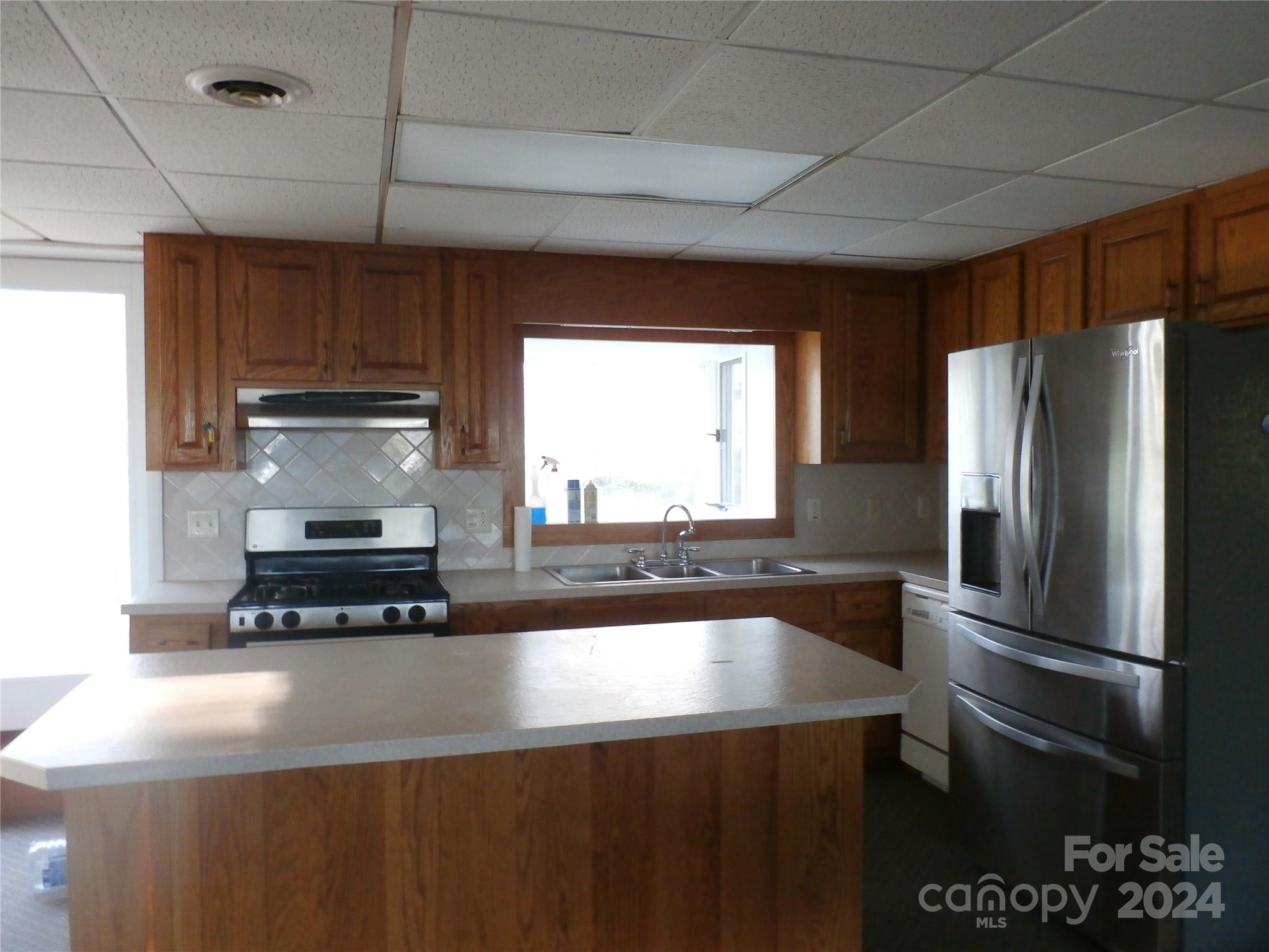 288 Firetower Road Spruce Pine, NC 28777 - Photo 6 of 47 a kitchen with a refrigerator and a sink