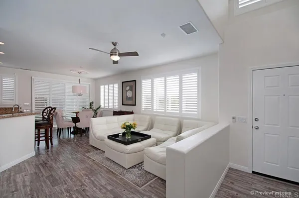 a living room with furniture and kitchen view
