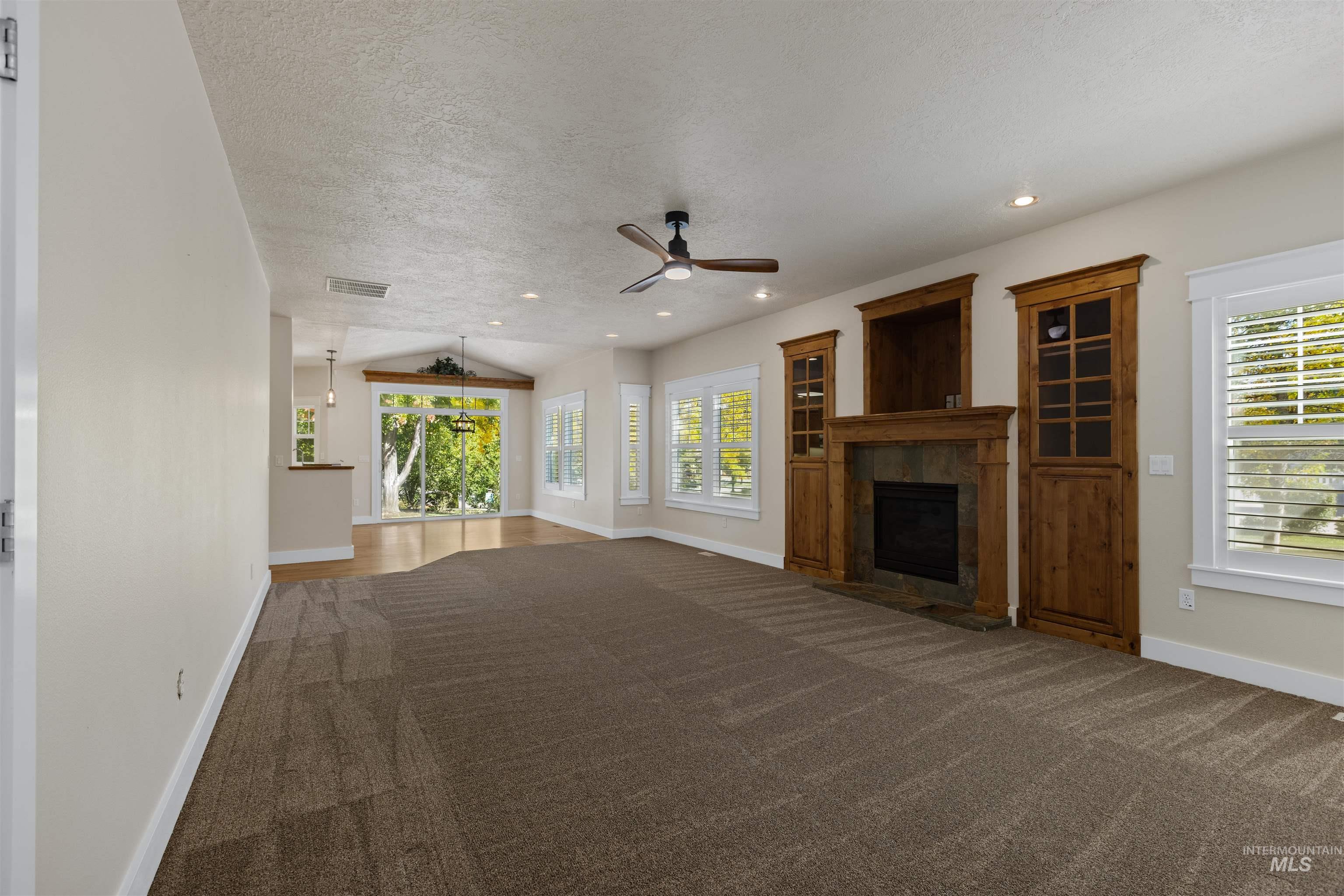 5426 West School Ridge Road Boise, ID 83714 - Photo 15 of 39 Expansive room featuring a ceiling fan, recessed lighting, and a fireplace with wood built-ins