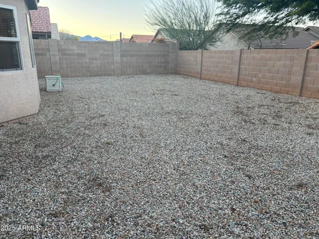 a view of a house with a yard and large tree