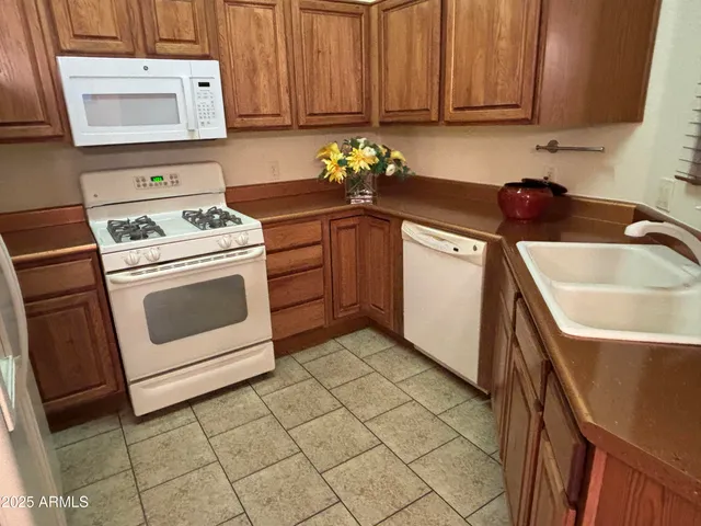 a kitchen with a stove top oven and sink