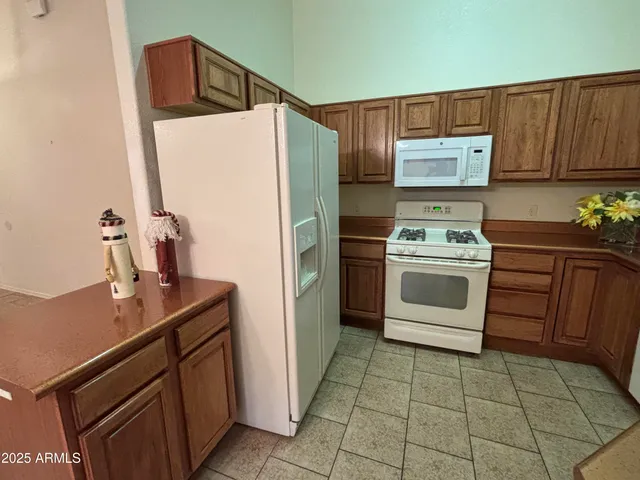 a kitchen with granite countertop cabinets stainless steel appliances and a sink